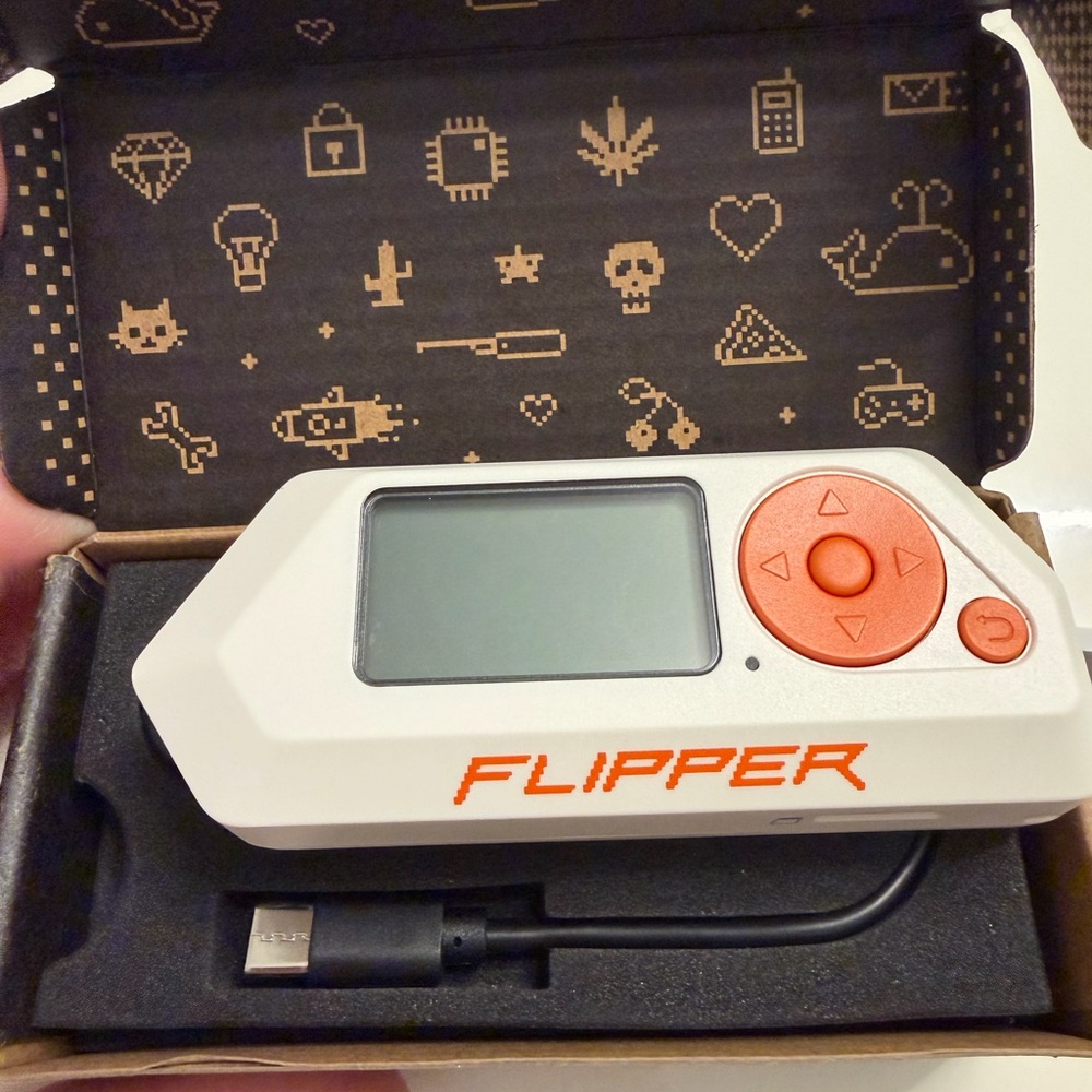 Flipper Device with Orange Accents